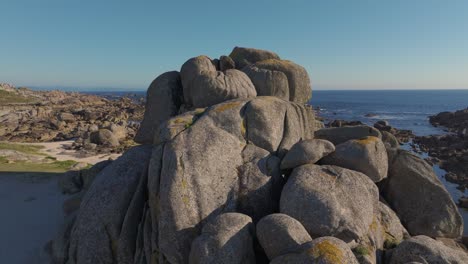 Boulders On The Shores Of Con Negro Beach In San Vicente do Grove In Galicia, Spain. Aerial Drone Shot
