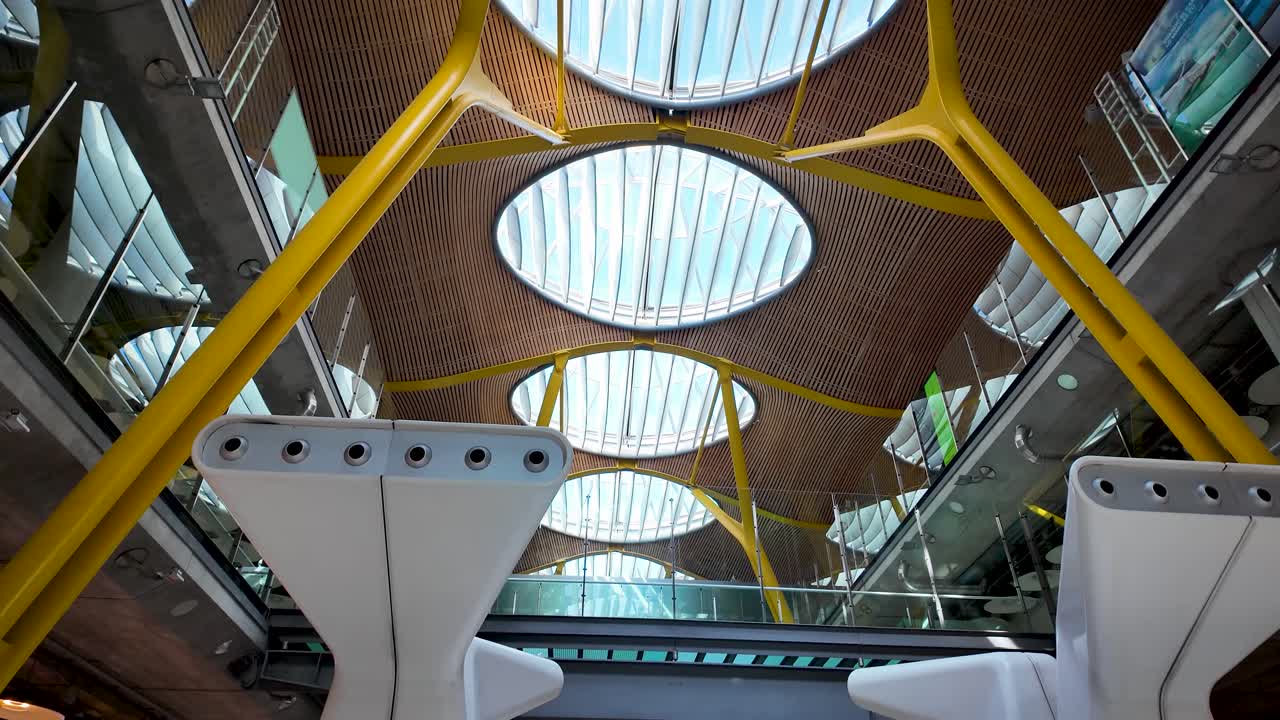 Descending shot of the baggage claim area inside Adolfo Suárez Madrid-Barajas International Airport, Spain