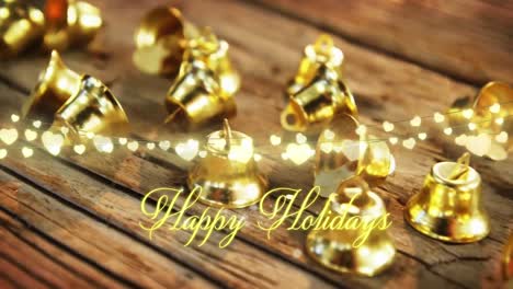 animation of text, happy holidays, in yellow, over string lights and christmas bell decorations