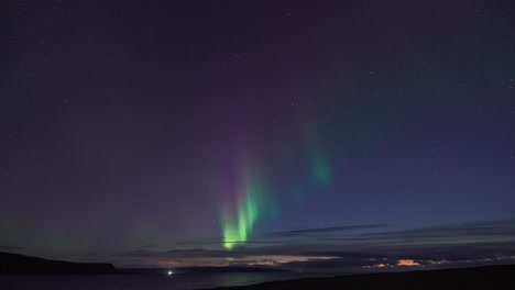 el cautivador baile de la aurora boreal en el cielo de invierno ilumina las oscuras aguas tranquilas del fiordo.