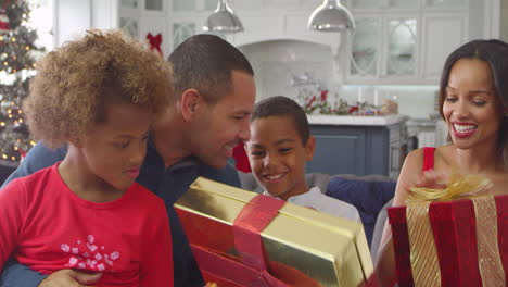 children giving christmas presents to parents shot on r3d