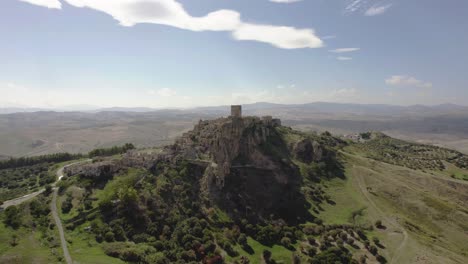 Drone-flying-in-large-circulair-motion-around-the-old-ruins-of-Craco-on-a-hill-in-the-south-of-Italy-in-4k