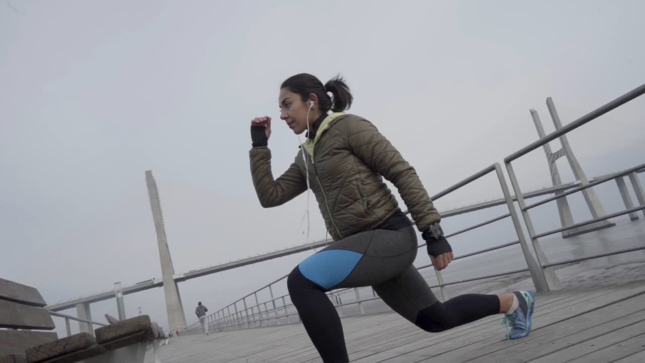 Focused sporty hindu woman with ponytail training outdoor