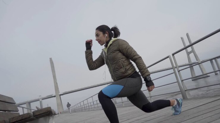 Focused sporty hindu woman with ponytail training outdoor