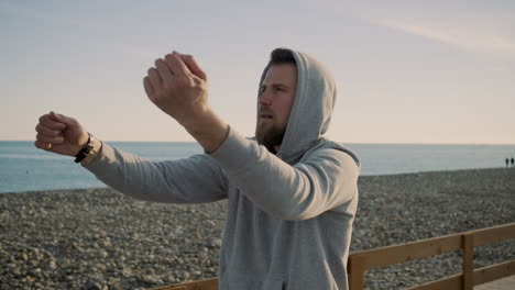 man stretching on a beach