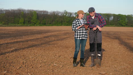 farmers using a tablet in a field