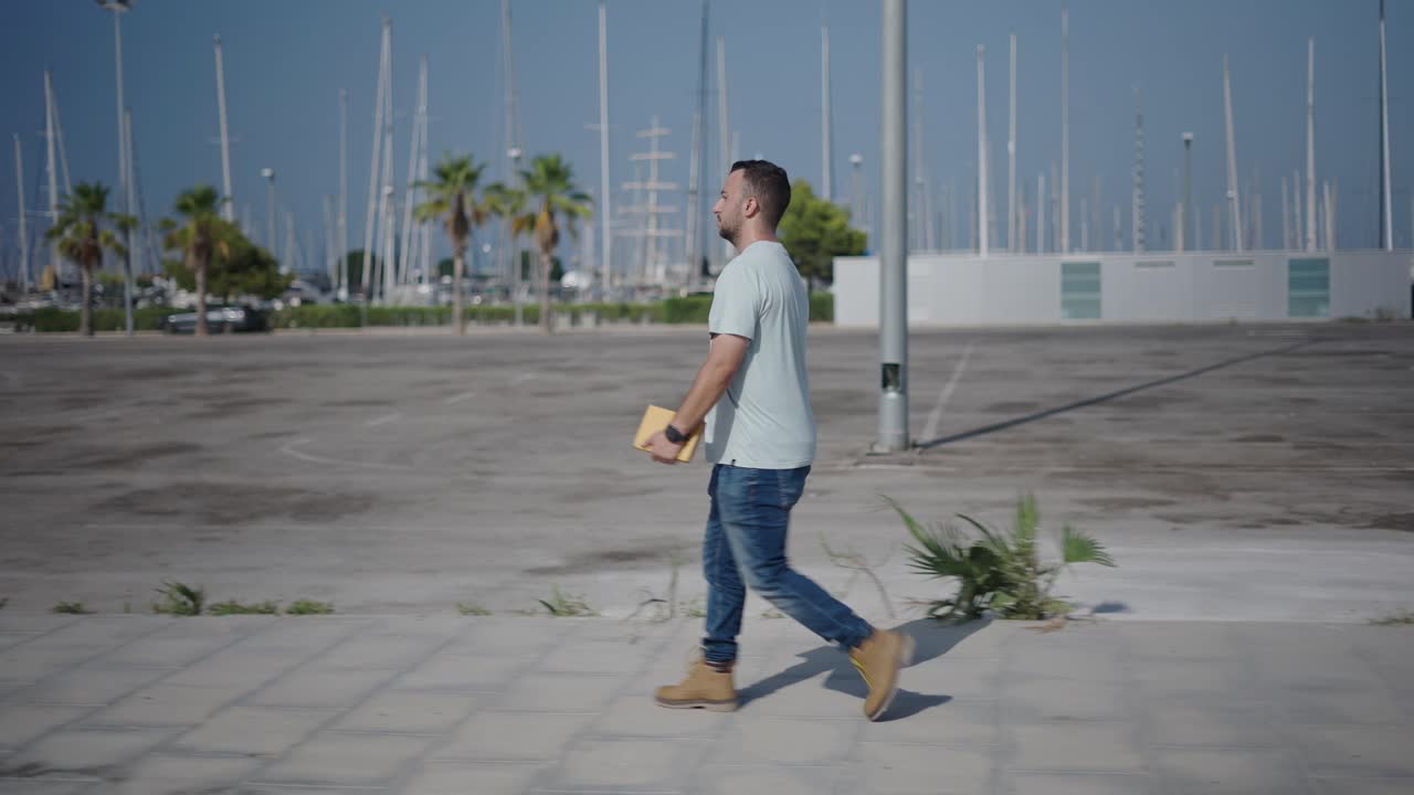 Man Walking on a City Street near a Port