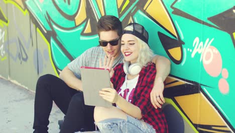 Laughing-young-hipster-couple-checking-a-tablet