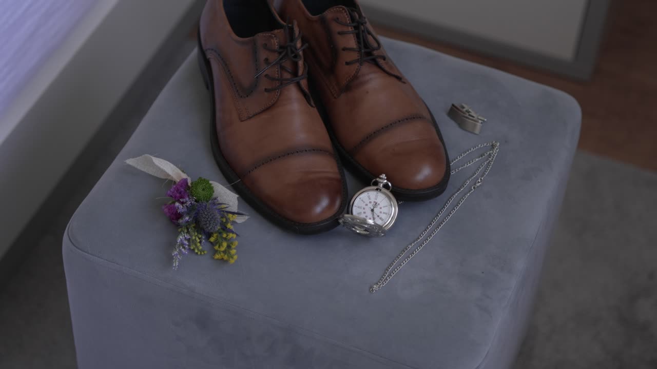 elegant groom details with leather shoes watch ring and floral boutonniere