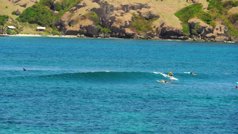 People-surfing-in-Lomboks-main-surfing-beach-spot-at-sunny-day