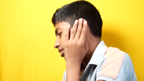 teenage boy having ear pain touching his painful ear