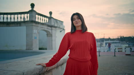 sensual brunette looking camera strolling city landmark walking sunset closeup