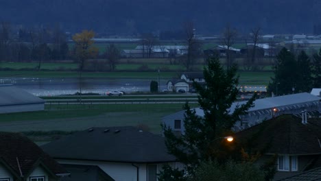 Vehicles-passing-at-highway-at-rainy-evening-weather-in-suburban-area