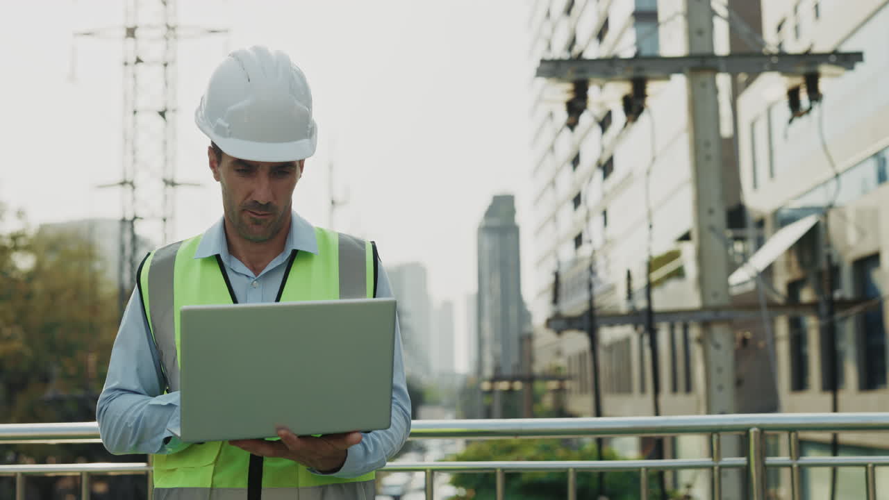 Engineer working with laptop outdoors