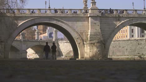 People-Walking-Under-Bridge