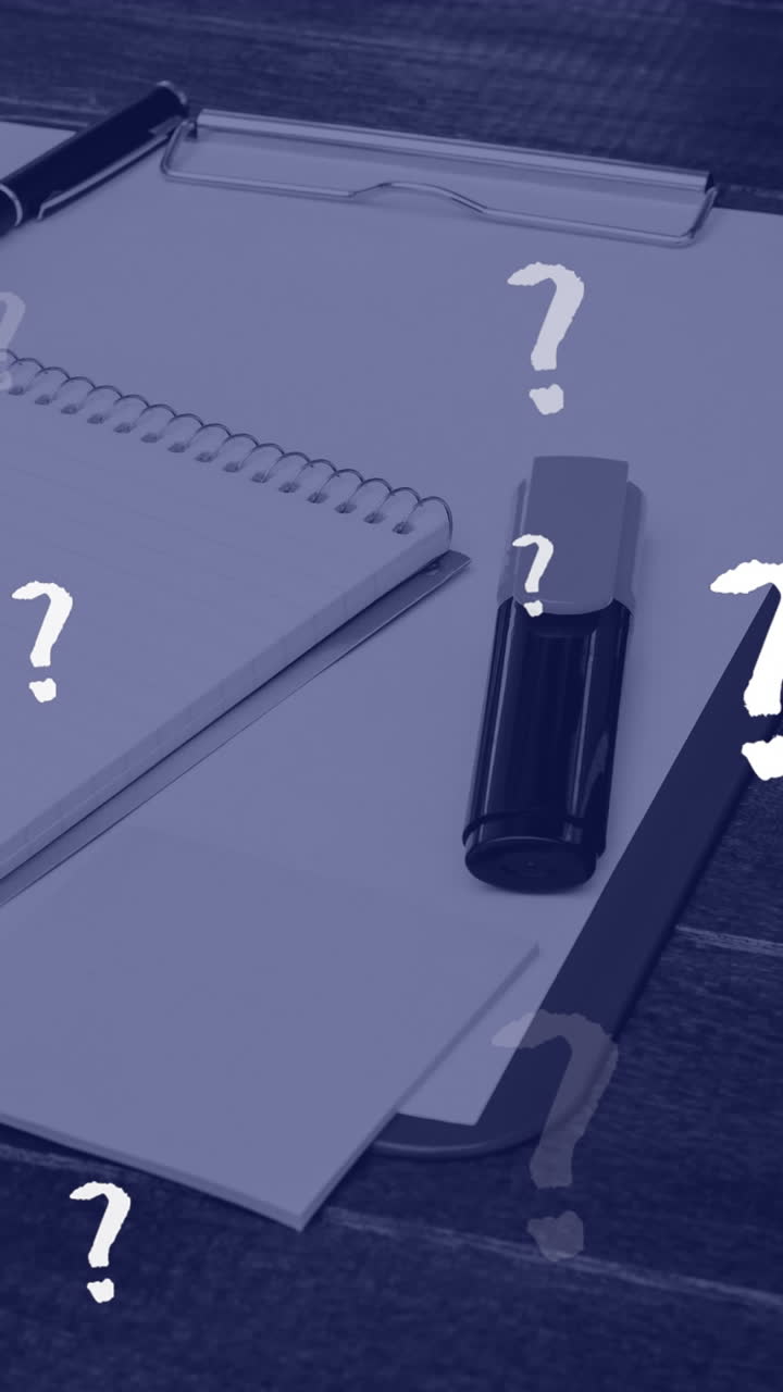 Animation of question marks floating over notepads and laptop on office desk