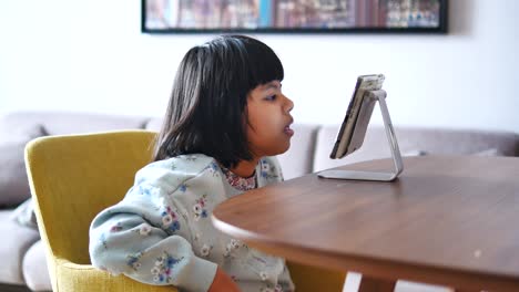 girl watching a video call on a tablet