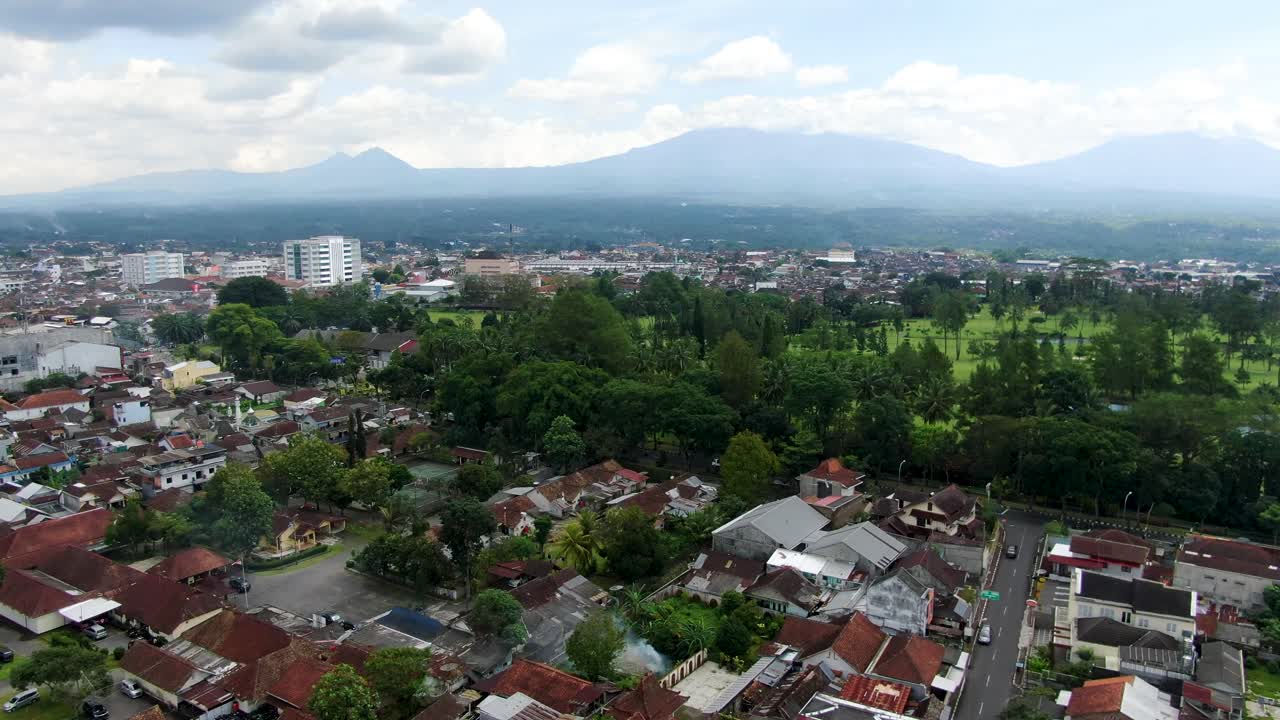 Tejados de la ciudad de Magelang y montañas en el horizonte, vista aérea con dron