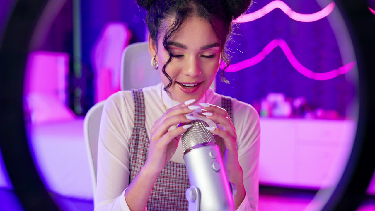 Woman recording podcast with microphone in studio setting