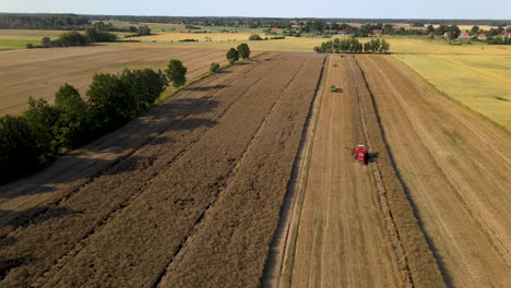 aerial view of combine harvesters on agricultural wheat field,backwards flight