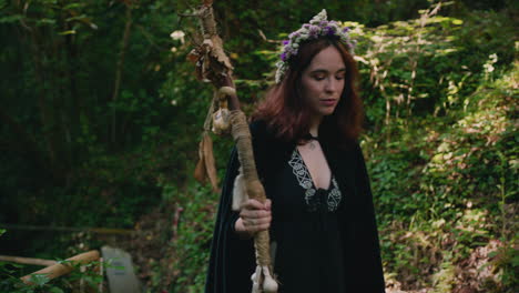 young druid girl walks and sits in a forest medium shot