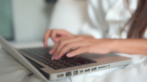 close up of female hands typing on laptop keyboard