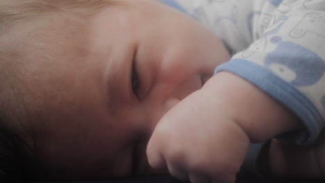 Baby-boy-laying-down-on-the-couch-on-his-side