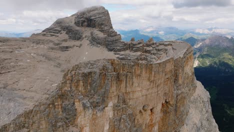 Breathtaking-drone-pull-back-shot-of-famous-Monte-Pelmo-Mountain-in-Italy-during-cloudy-sky