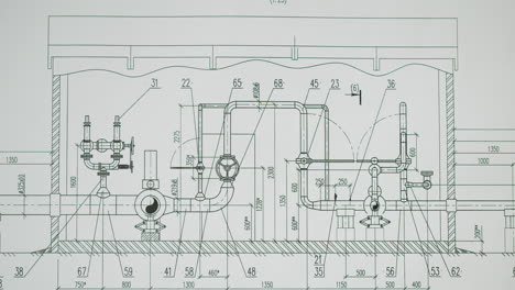 hand pointing at an engineering blueprint