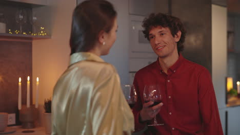 couple enjoys a romantic evening with wine at home
