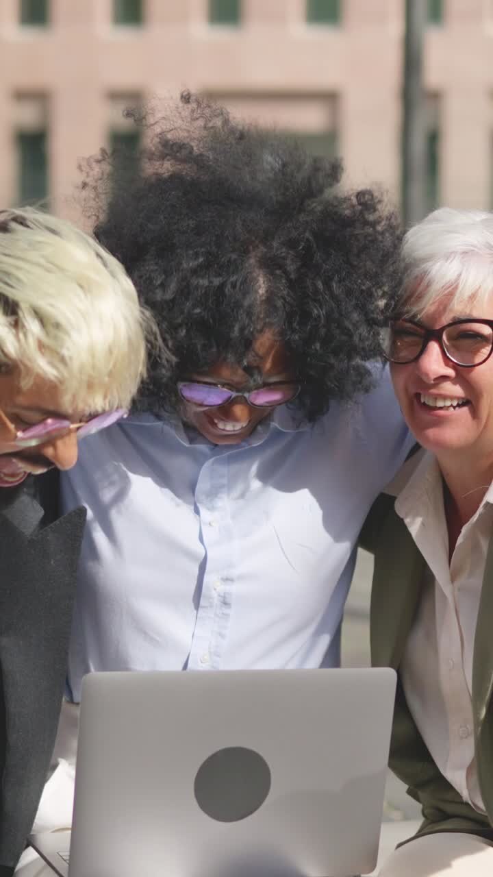 Group of People Collaborating Outdoors with a Laptop