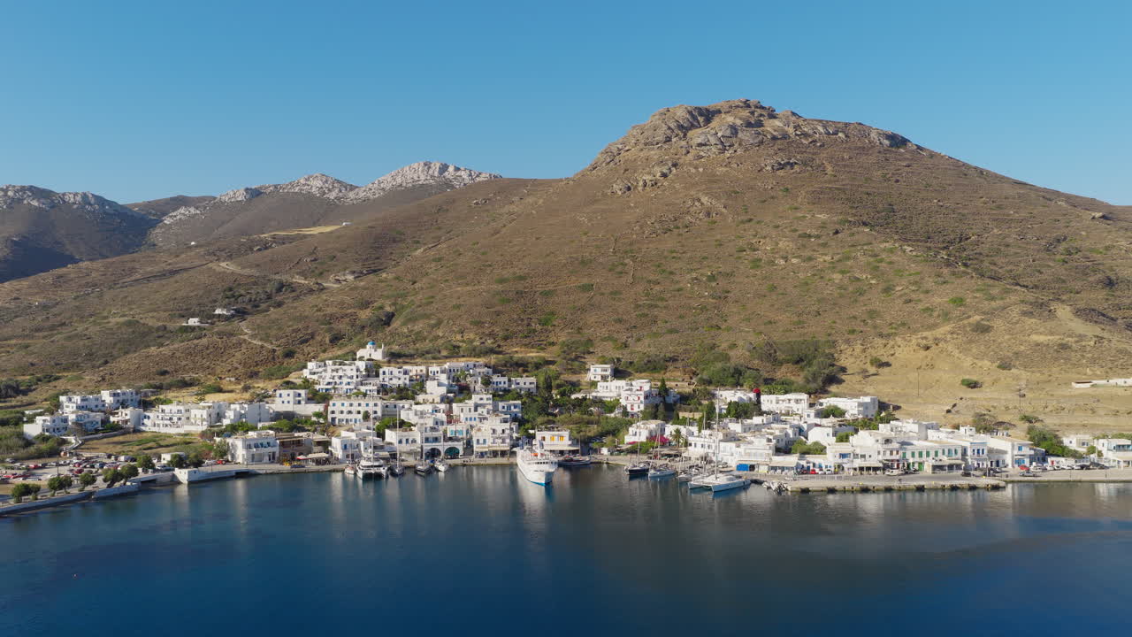 Katapola seaside port village on Amorgos island surrounded by mountains, Aerial pullback shot