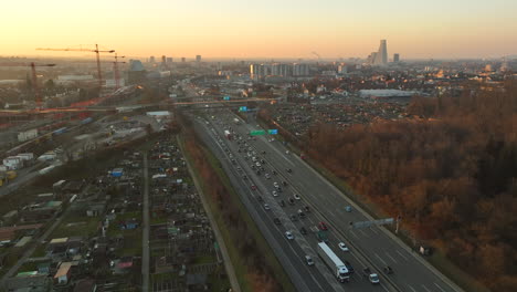 Cars-and-truck-driving-slowly-in-a-traffic-jam-on-the-highway-ring-of-Basel-during-sunset