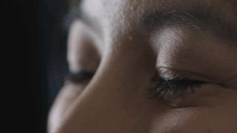 close up young woman eyes looking happy cheerful asian woman face on black background