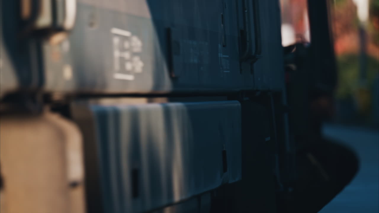 Close up of a train moving on the rails near a station in the south of France at sunset