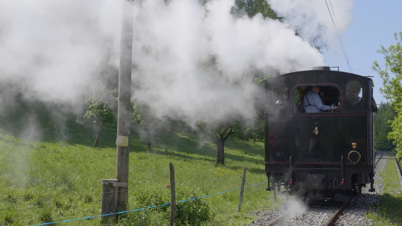 Narrow gauge steam locomotive driving away Blonay-Chamby museum track