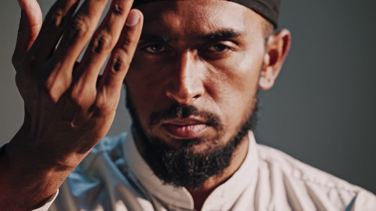 The video captures a serene moment of introspection, focusing on a man's contemplative expression