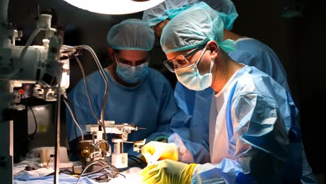 surgeons performing a critical procedure in an operating room at night