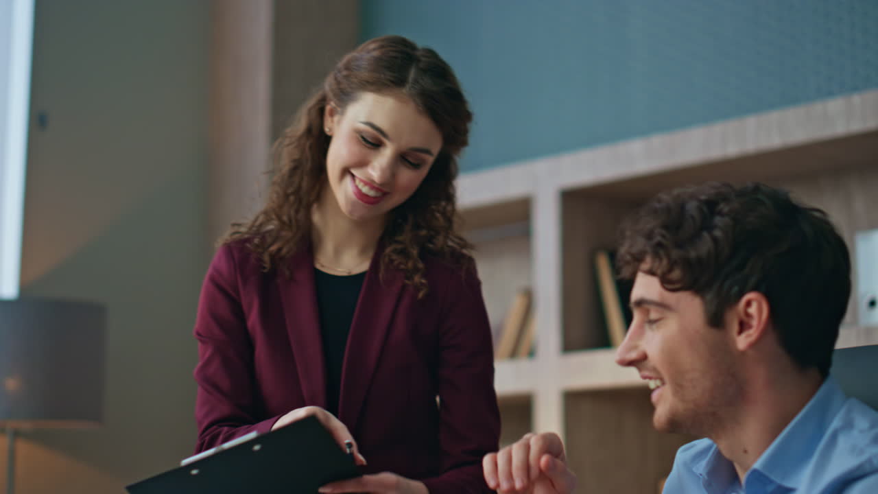 Busy boss taking coffee from smiling woman assistant in corporate office closeup