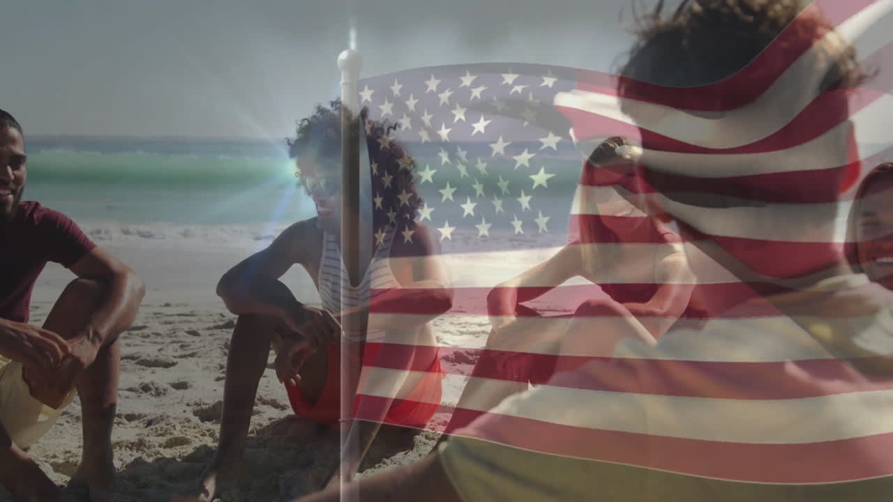 American flag overlaying scene, group of adults relaxing on beach together