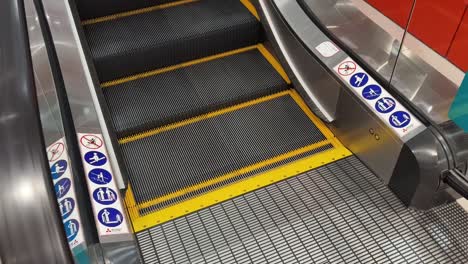 escalator with safety signs