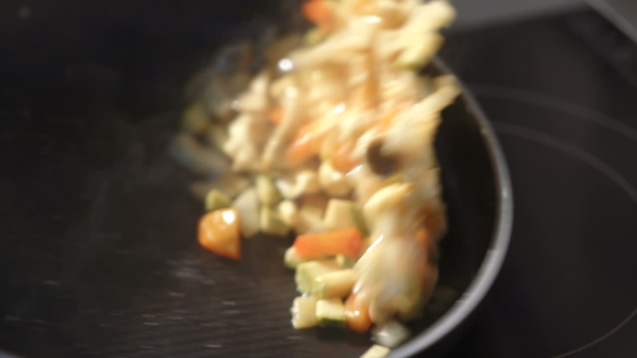 Man cooking vegetable stew. Sliced fresh vegetables in pan with spices and ingredients
