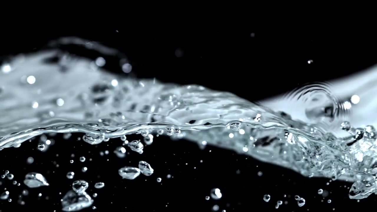 Dynamic Slow Motion Water Splash with Bubbles Against Black
