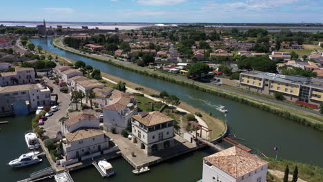 aerial back traveling over a boat in a canal along marina du port du roy