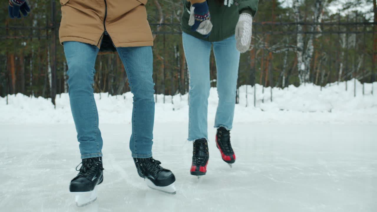 Couple Ice Skating Outdoors in Winter