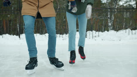couple ice skating outdoors in winter
