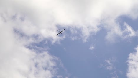 glider in the sky with white clouds