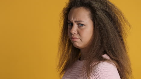 Upset-Caucasian-curly-haired-woman-in-front-of-the-camera.