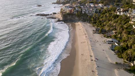 aerial view of california beach with the ocean waves breaking into the shore