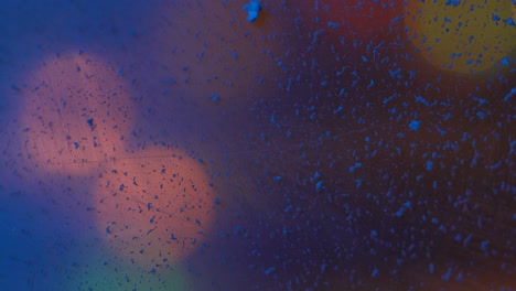 reflection on the dirty surface of a multi-colored glow 4k